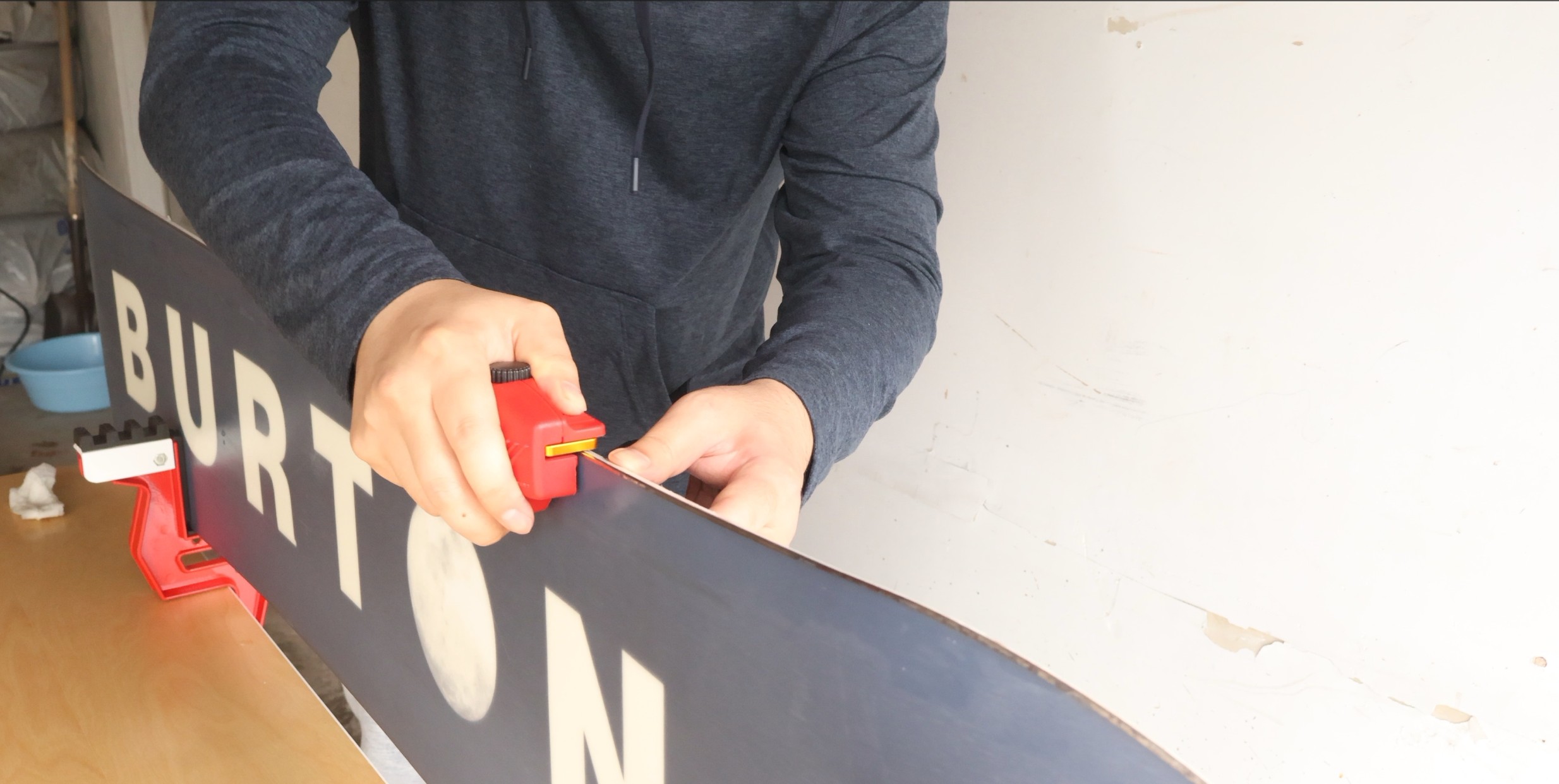 Sharpening snowboard edges with diamond stone and guide