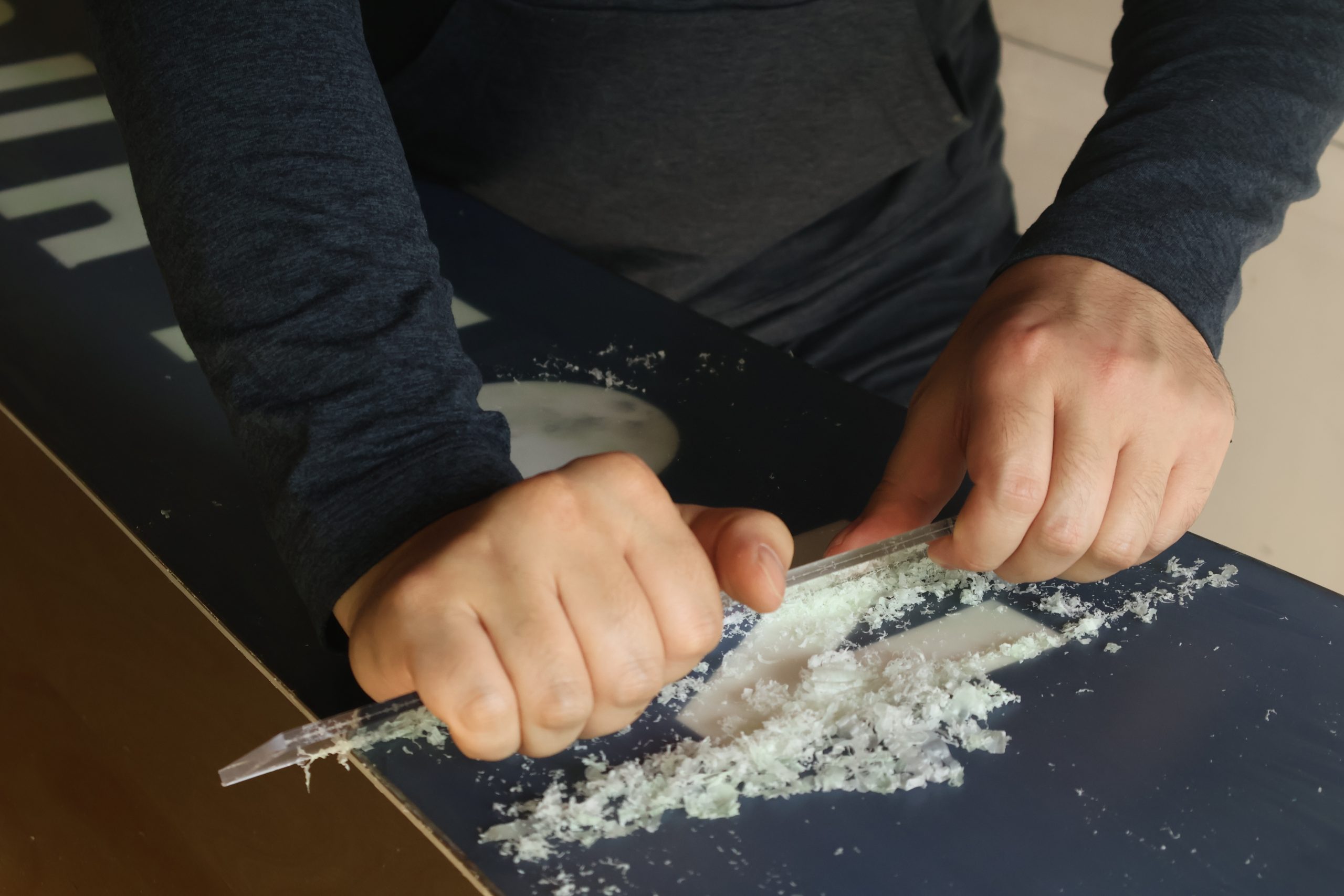 How to wax snow board Step 5: Scraping Wax off of Snowboard