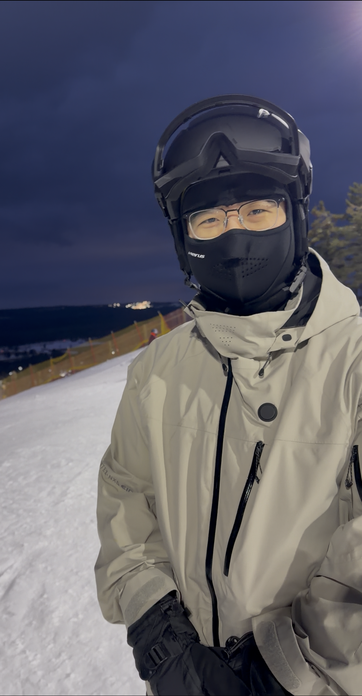 Kaison, author of Kaison Snow Guide, smiling while standing on top of a mountain snowboard run
