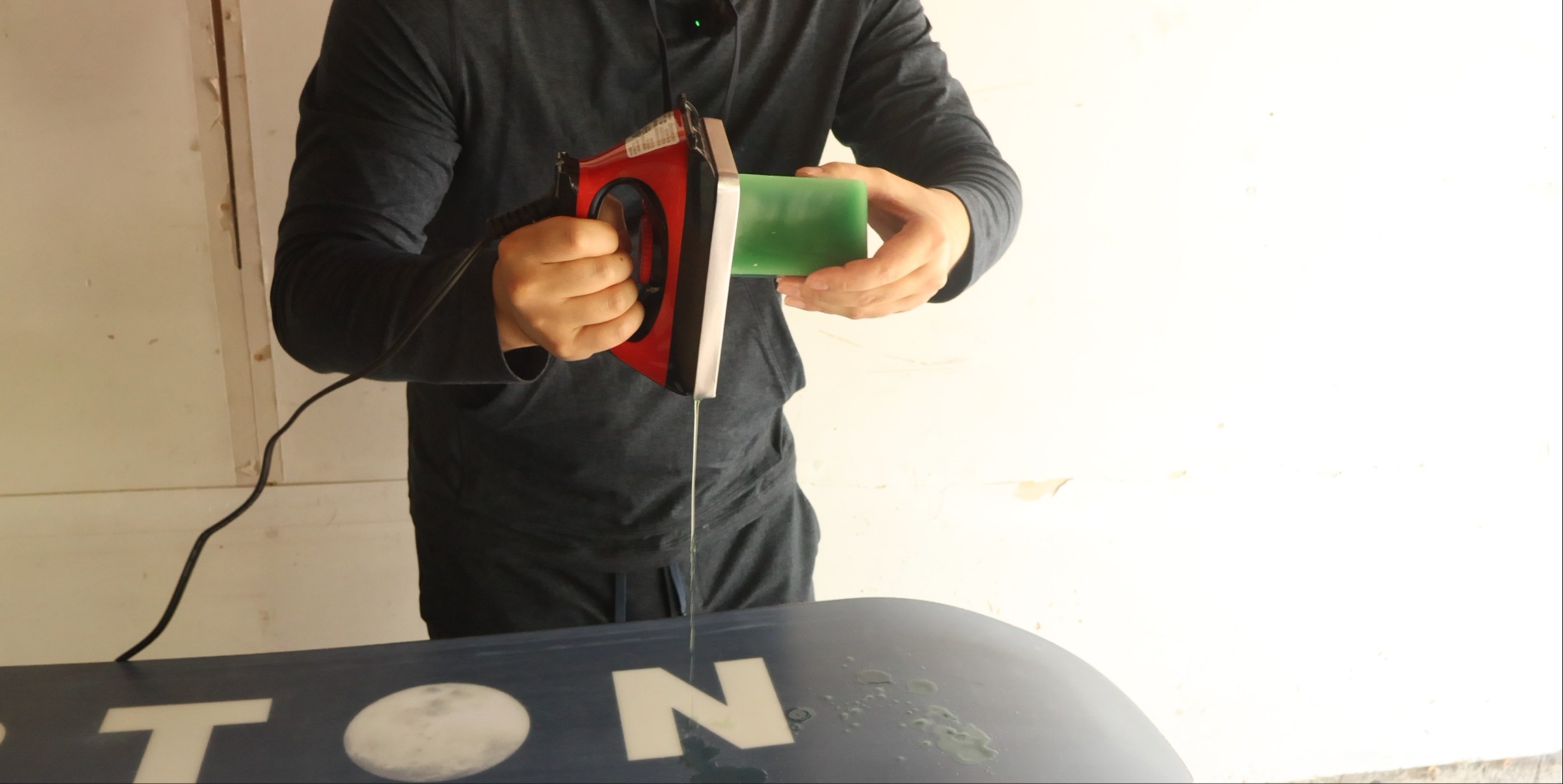 dripping wax onto snowboard